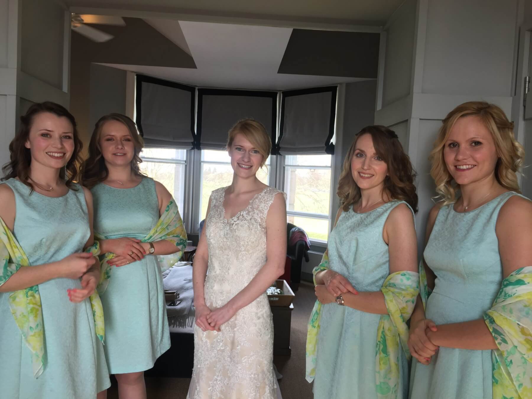 Bride with her bridesmaids on her wedding day with bridal makeup by Bristol makeup artist Evie Smith.