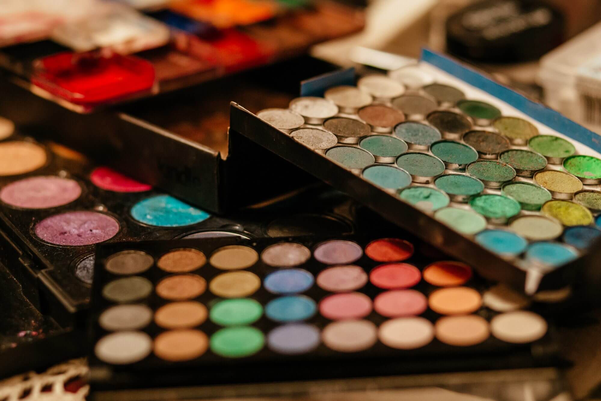 Stock photo of makeup palettes laid out artistically.