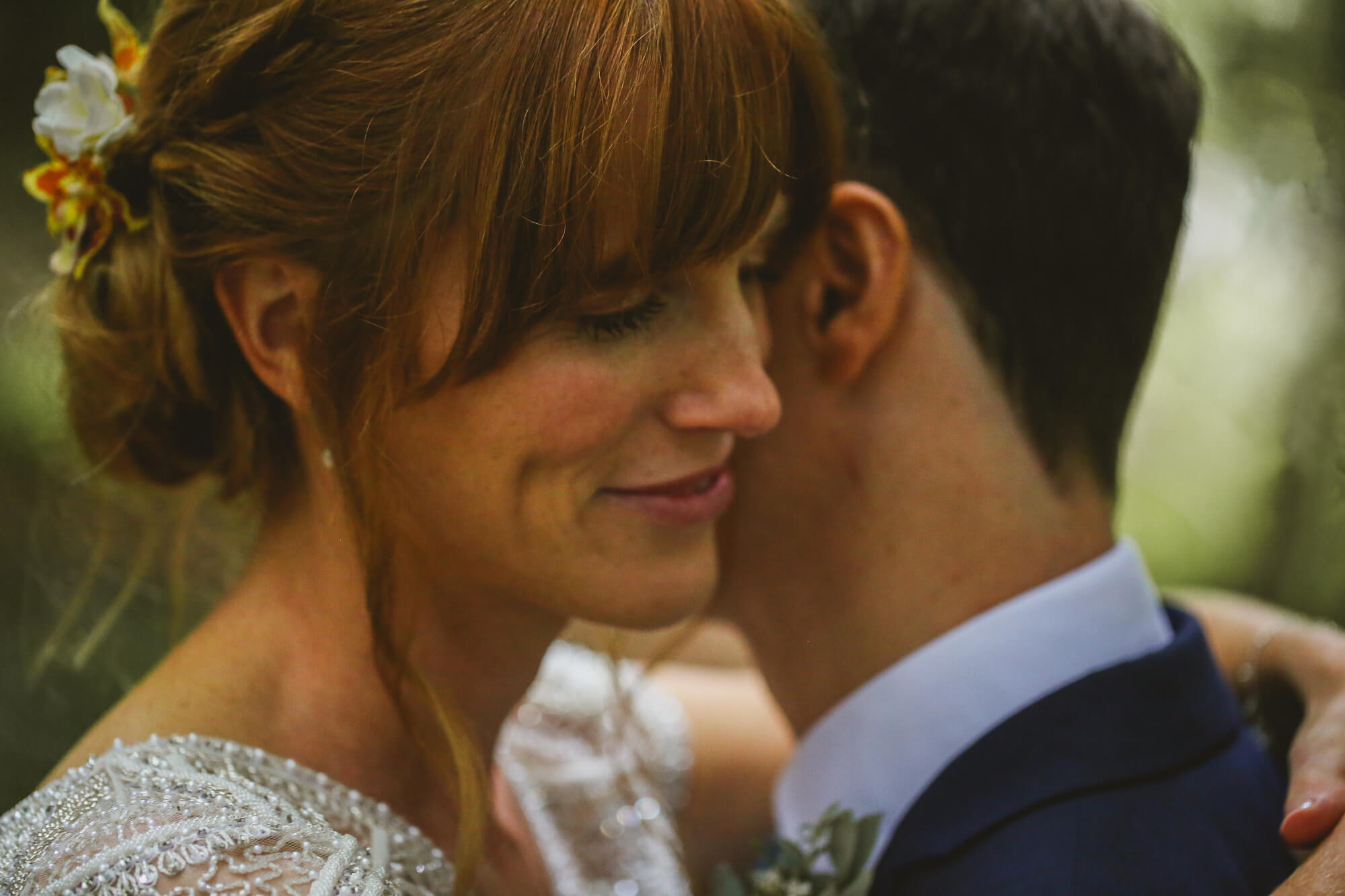 Close up of bride and groom embracing on their wedding day. Bridal makeup by Bristol makeup artist Evie Smith