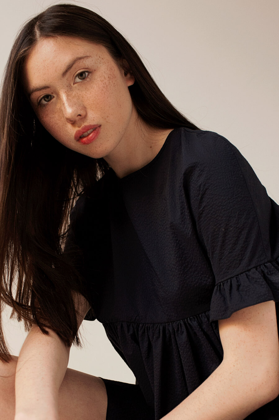 Commercial model posing for the camera with makeup by Bristol makeup artist Evie Smith