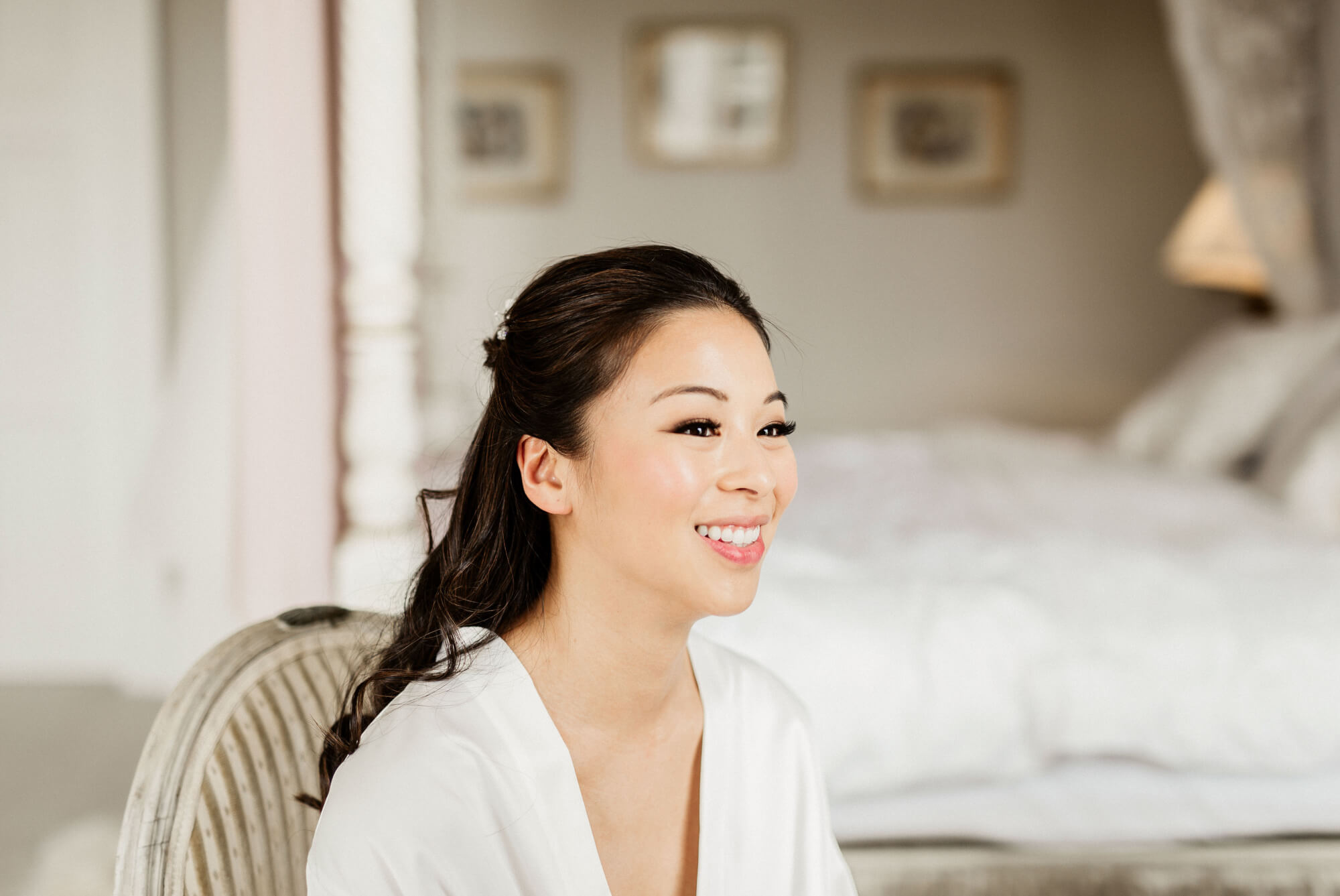 A happy bride on their wedding day with professional bridal hair and makeup by Bristol makeup artist Evie Smith.