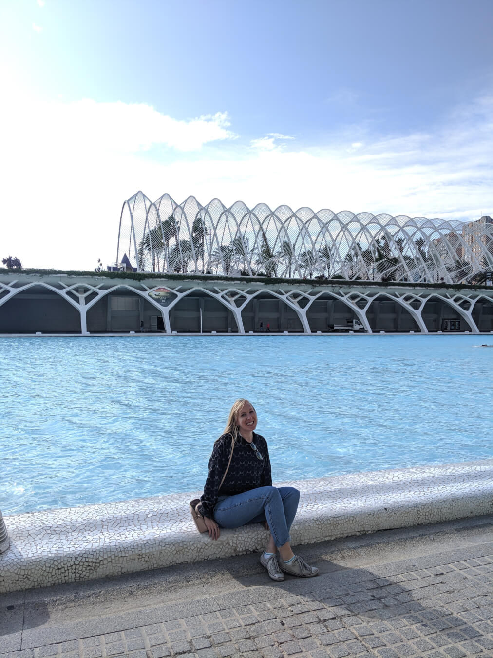 Bristol makeup artist Evie Smith sitting by pool side.