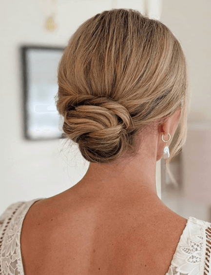Photo of Bride from behind showing professional hair and makeup by Bristol makeup artist Evie Smith.
