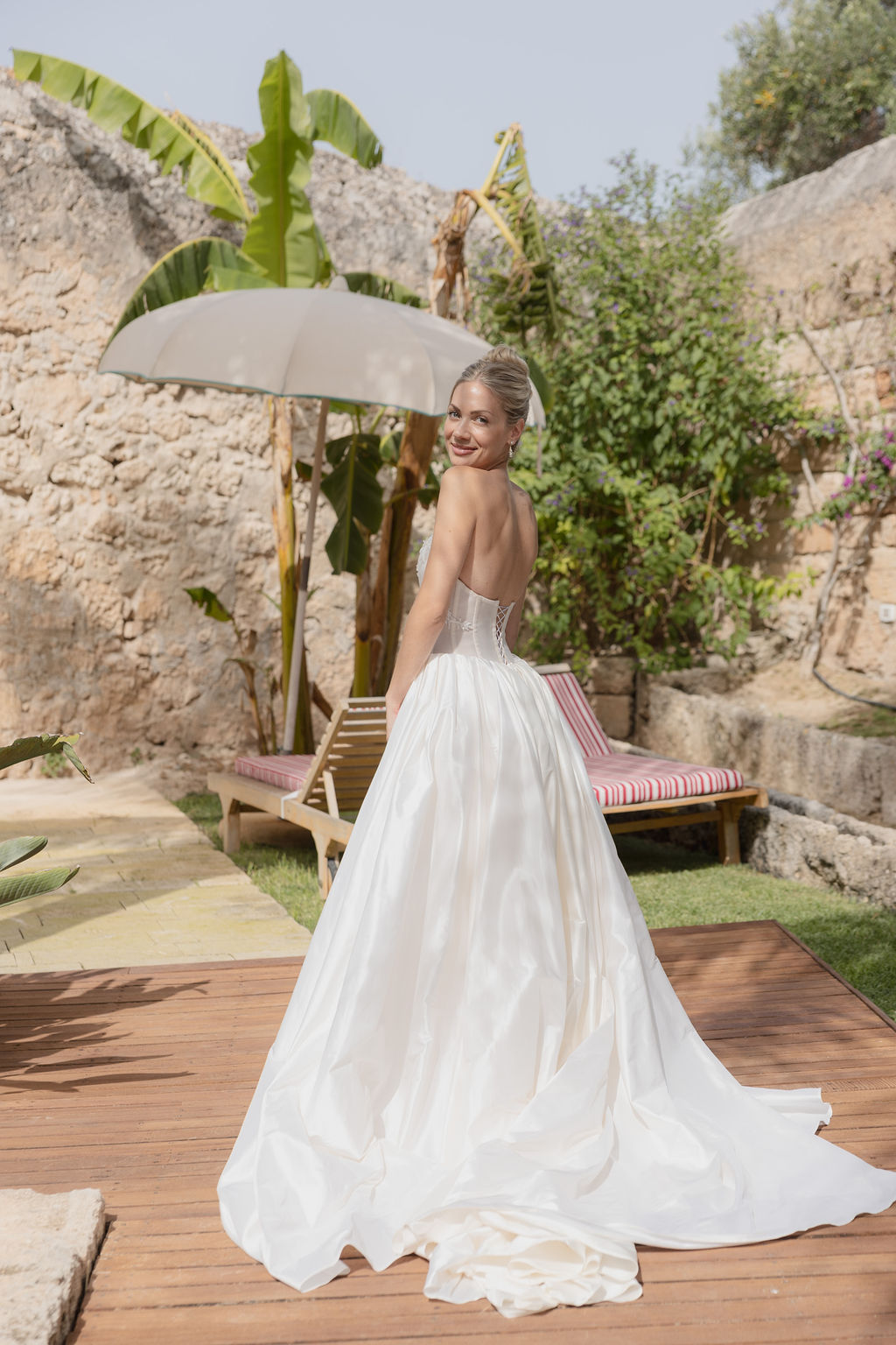 blonde woman looking back towards the camera in a masseria in southern italy