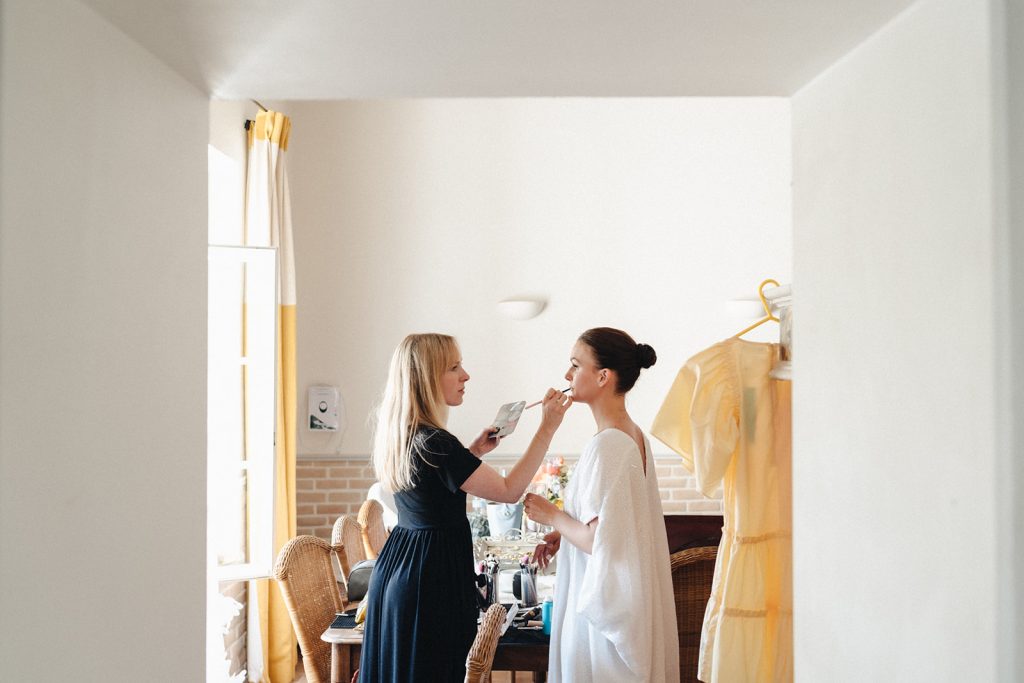 Professional makeup artist Evie Smith applies bridal makeup to bride for destination wedding in Provence.