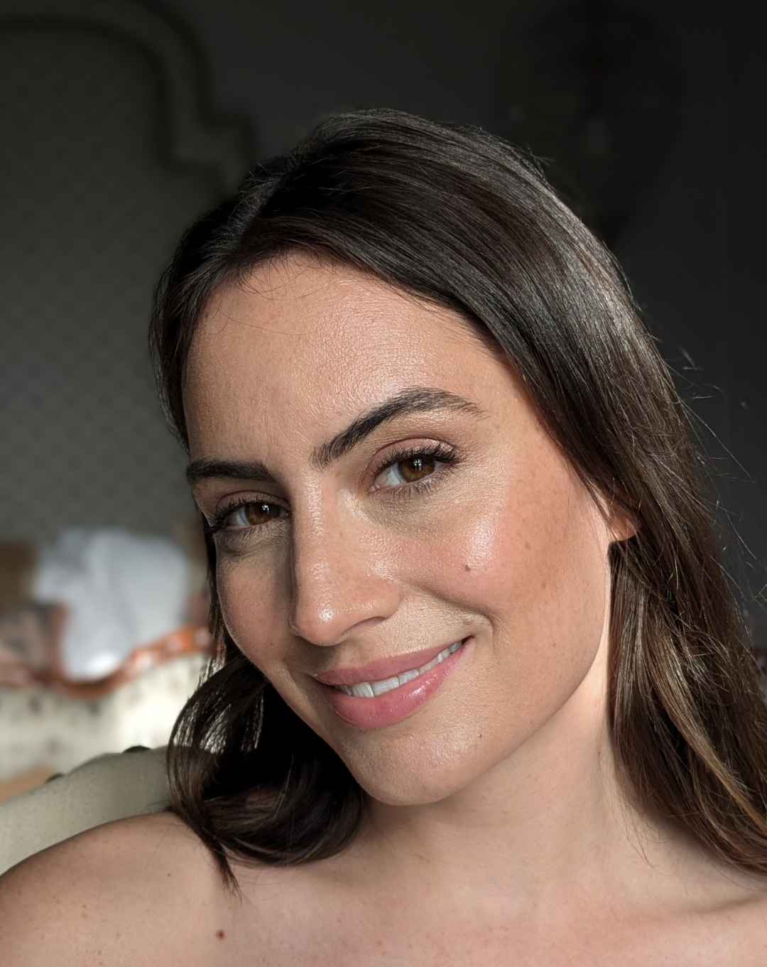 a brunette woman staring into the camera and smiling