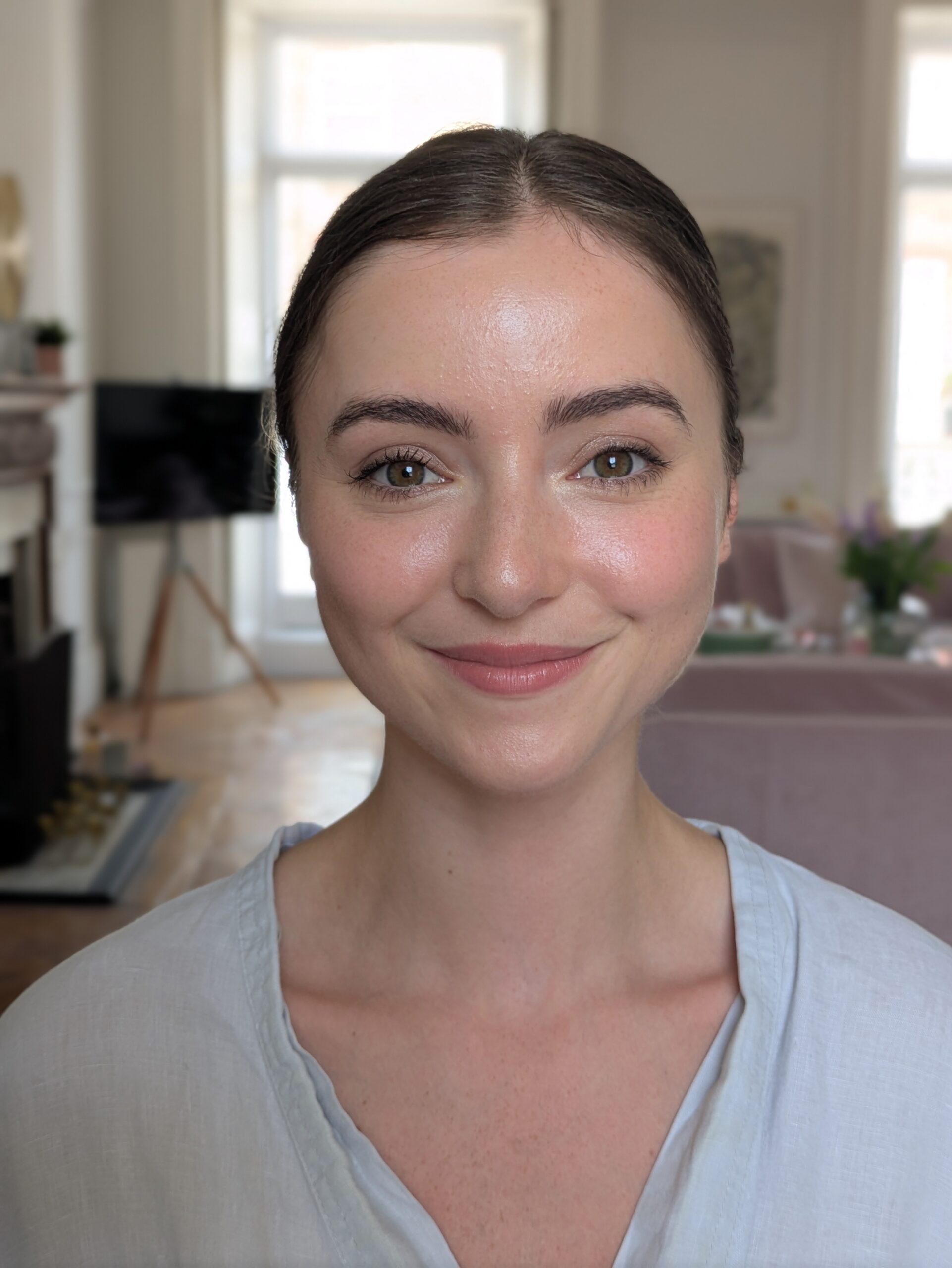 a bride looking into the camera. her makeup is fresh and natural. she is smiling. wedding in london.